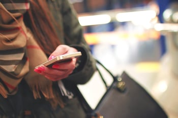 Women replying to a text message on an iPhone