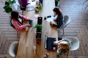 Three women working together on laptops